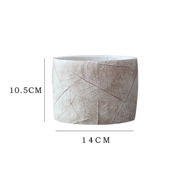 Decorative plant container made of handmade ceramic with leaf pattern