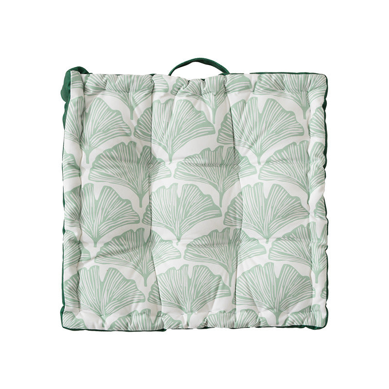 Padded chair cushion with carrying handle and decorative stitching