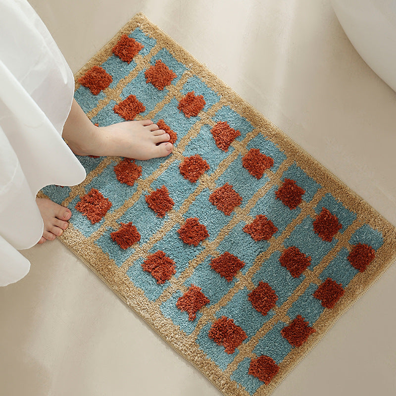 Hand-tufted bathroom bath mat with non-slip backing and textured square relief