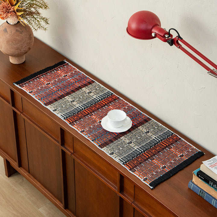 Woven table runner in ethnic look made of cotton blend with fringes
