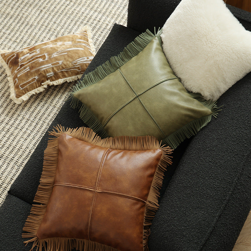 Decorative faux leather cushion with fringes and decorative seam
