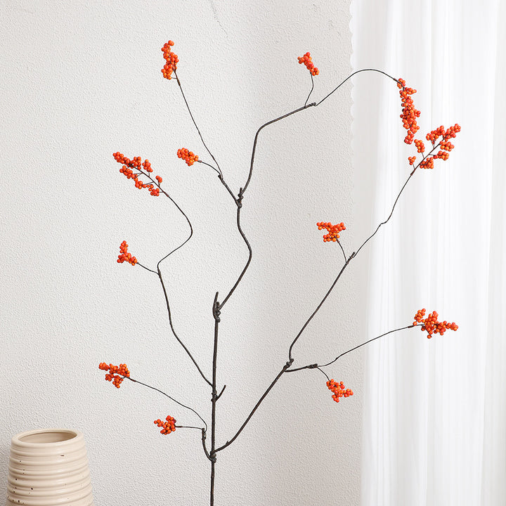 Decorative artificial flower branch with glowing red berries