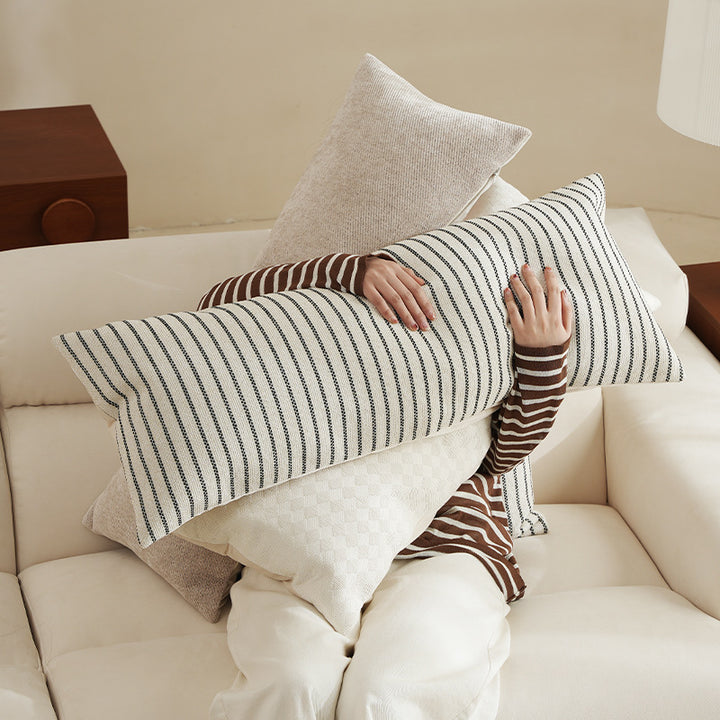 Long rectangular lumbar and neck pillow with textured woven look and concealed zipper