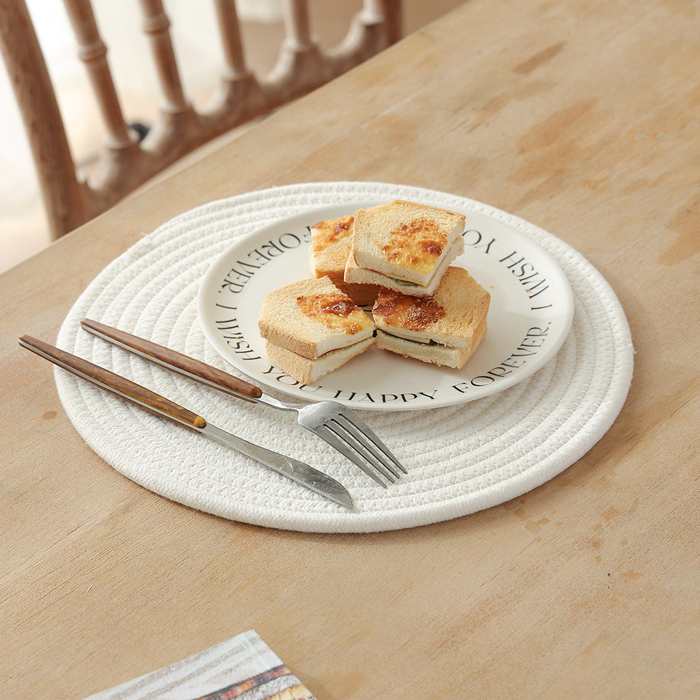 Braided round table mat made of cotton rope and sea grass with spiral structure