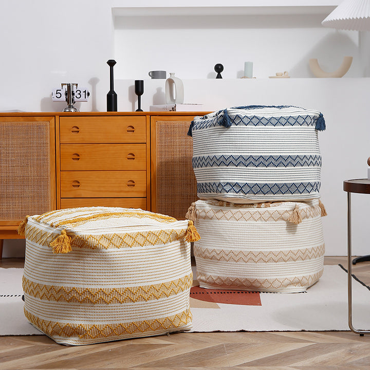 Braided square floor seat pouf with tassels and woven ethnic pattern