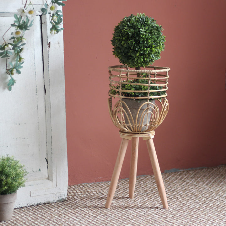 Stylish plant stand made of rattan and wood
