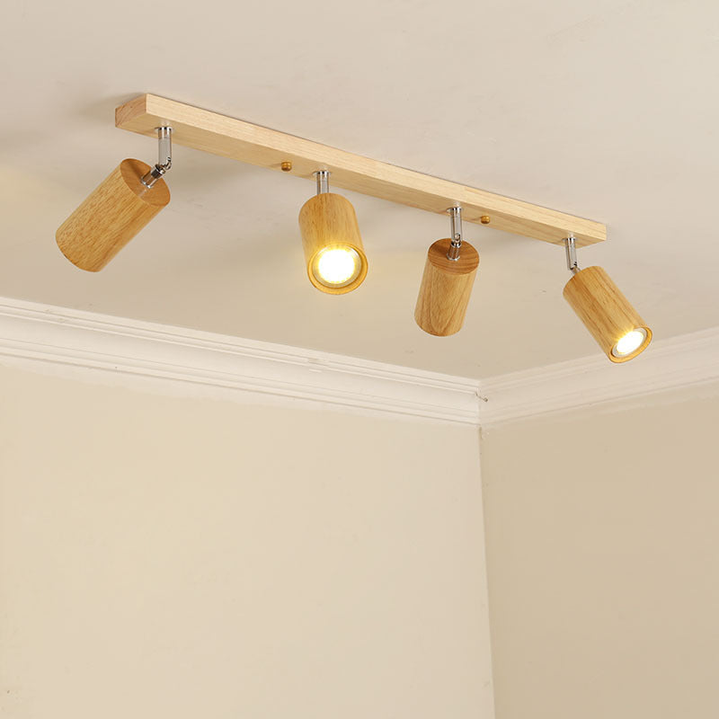 Wood beam ceiling rail with adjustable cylinder spotlights