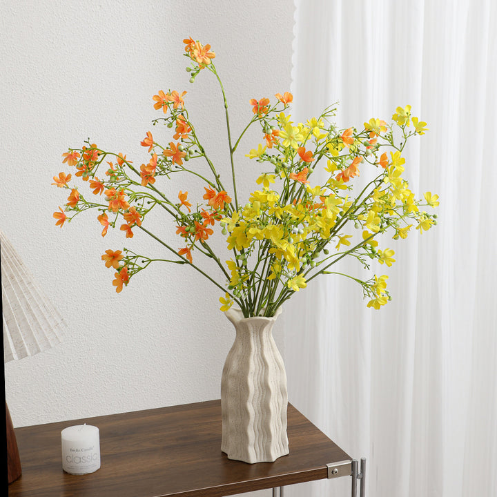 Artificial flower branch with delicate blue flowers and green berries