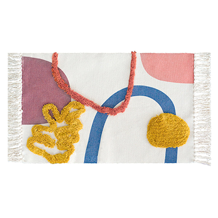 Hand-tufted bathroom mat with fringes, decorative dot-and-dash pattern and non-slip backing