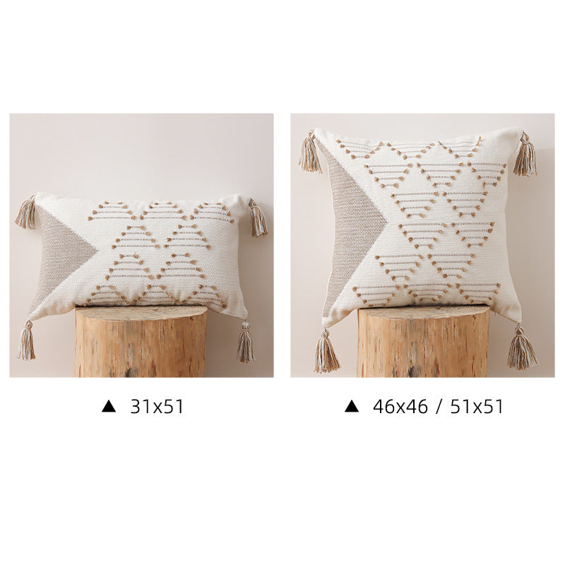 Decorative woven cushion cover with geometric tuft-relief and tassels