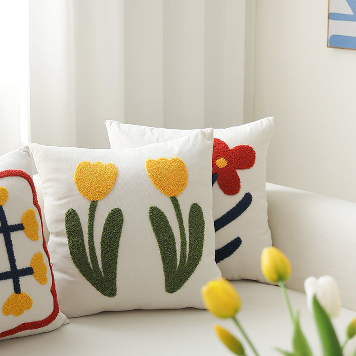Square decorative cushion with hand-tufted heart ornament and contrasting border