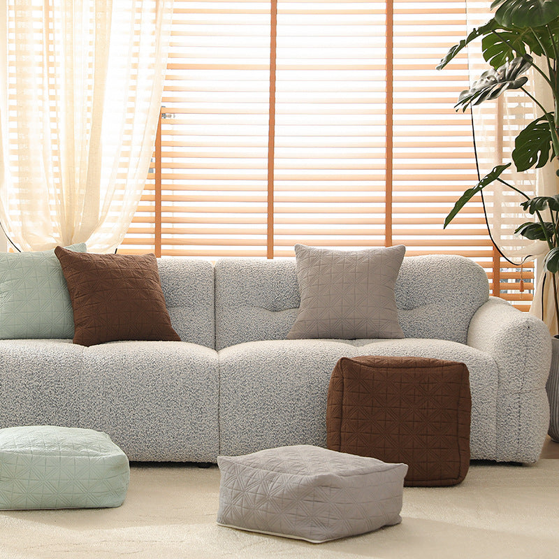 Padded footstool pouf with quilted cover fabric and shape-stable core
