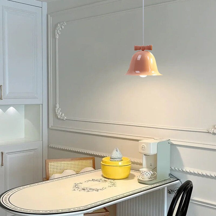 Bell-shaped ceramic pendant light with decorative bow accent