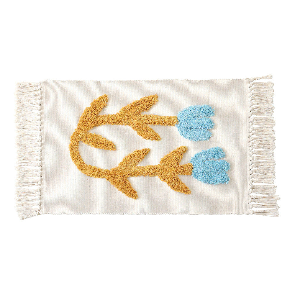 Handwoven cotton bath mat rug with tufted flower appliqué and tassels