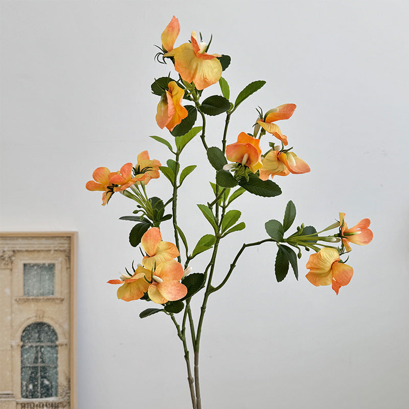 Artificial flower branch with vibrant pink flowers
