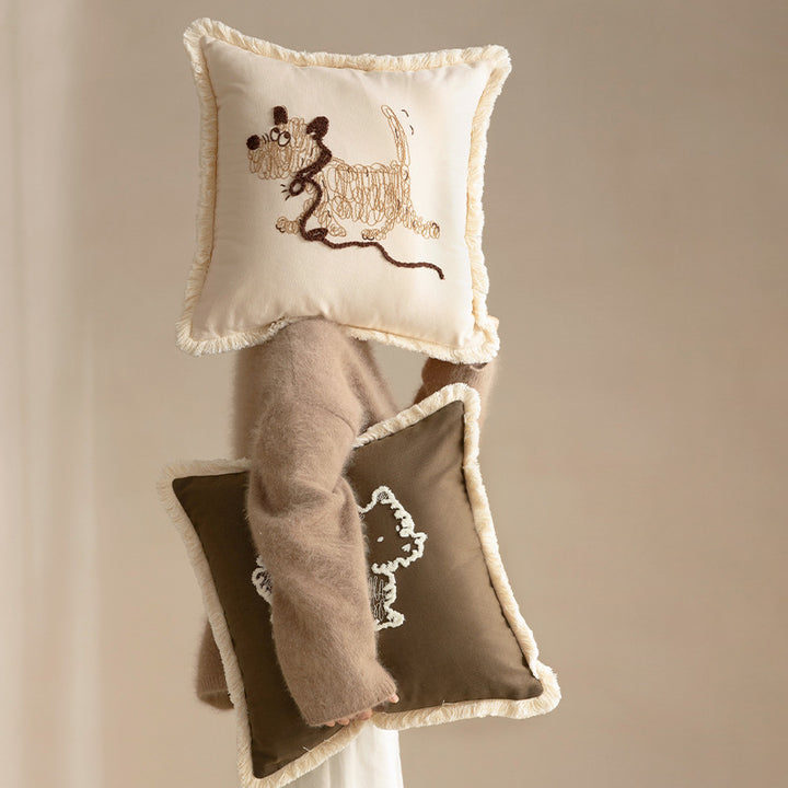 Decorative cushion cover with embroidered dog motif and fringed border