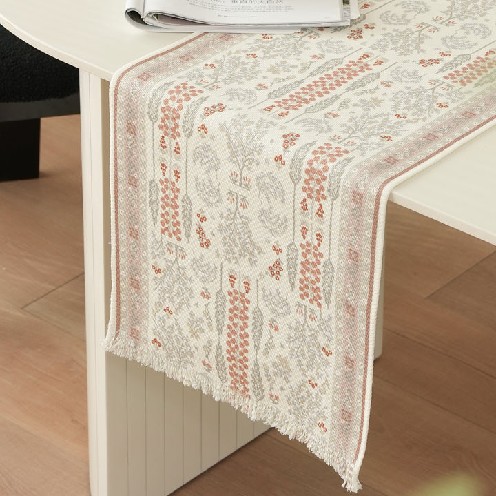 Woven jacquard table runner with floral medallion and fringes