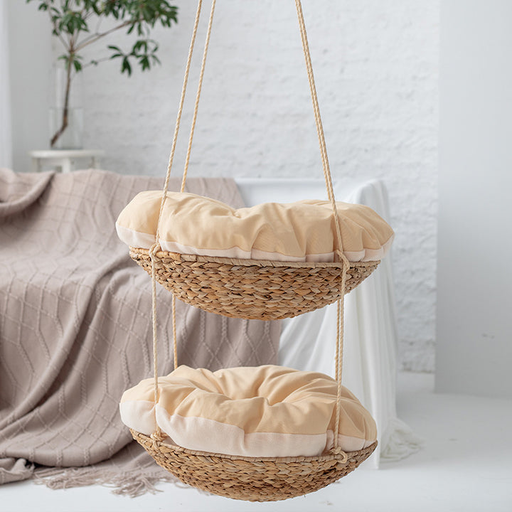 Hanging chair made of braided natural material with comfortable cushions
