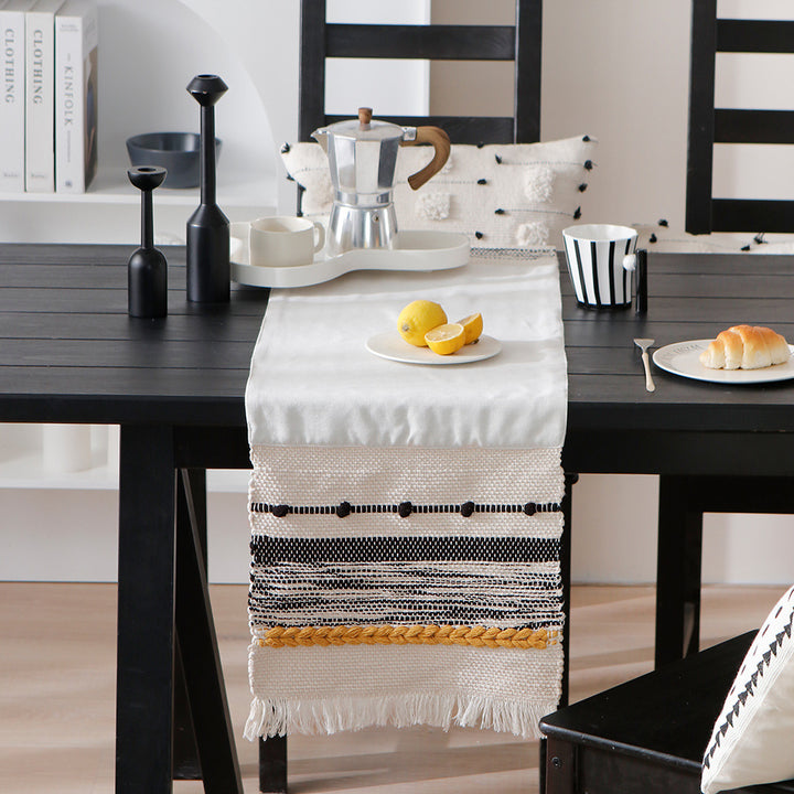 Woven cotton table runner with boho stripes, fringes, and textured woven edge