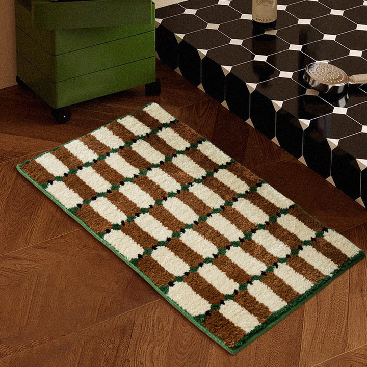 Hand-tufted bathroom mat with a velvety pile, non-slip latex backing, and geometric honeycomb check pattern