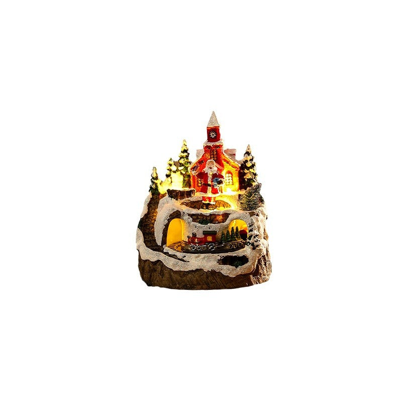 Illuminated Christmas village scene with snowman