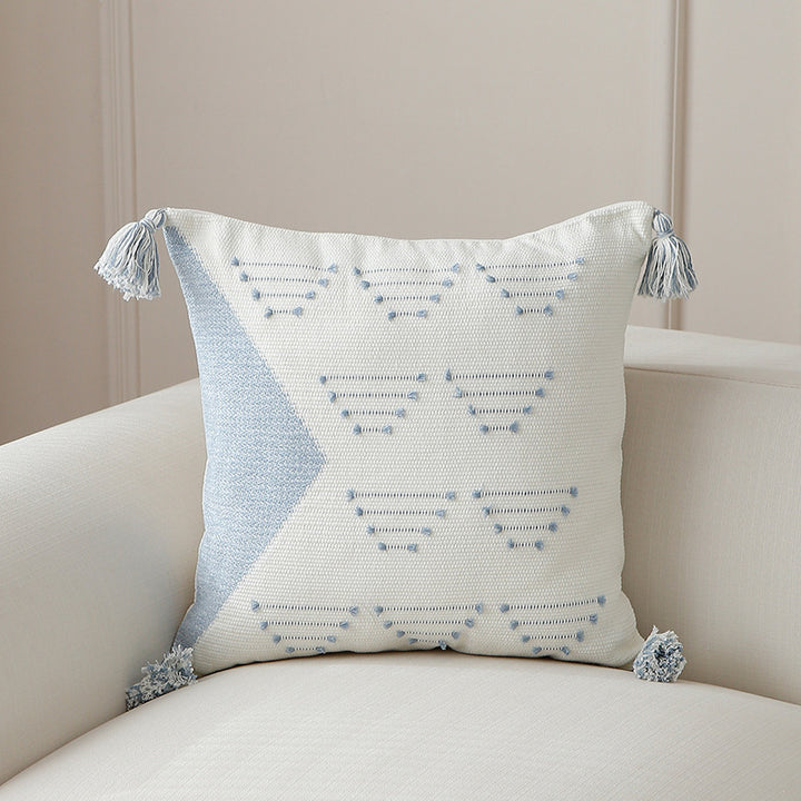 Decorative woven cushion cover with geometric tuft-relief and tassels