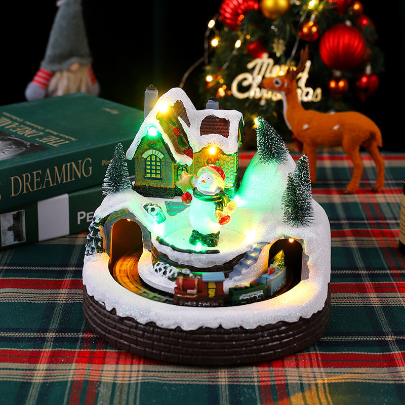 Illuminated Christmas village decoration with moving figures