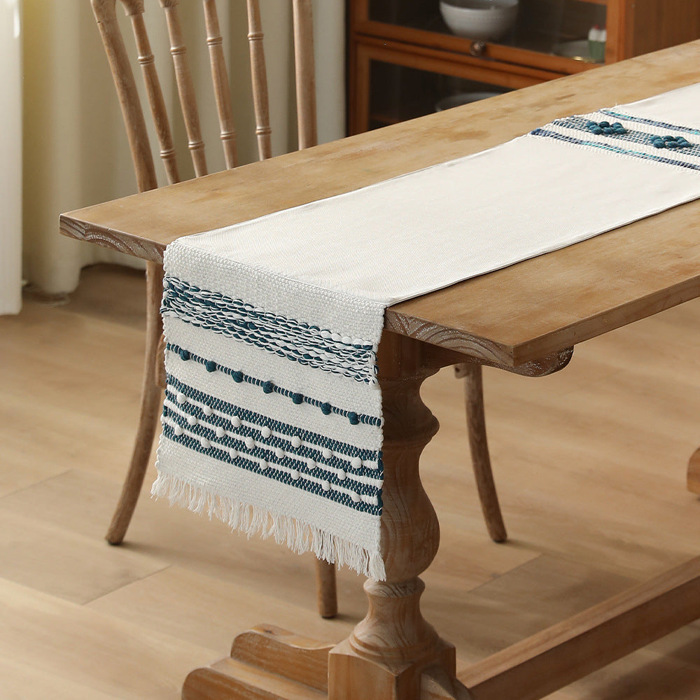 Woven cotton table runner with fringes and textured pattern