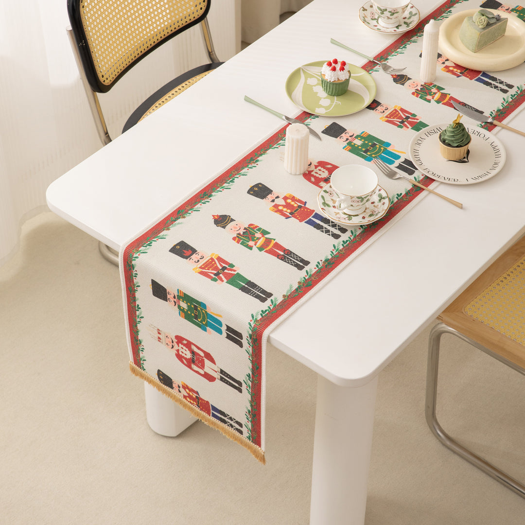 Festive woven table runner with nutcracker motif and golden fringes