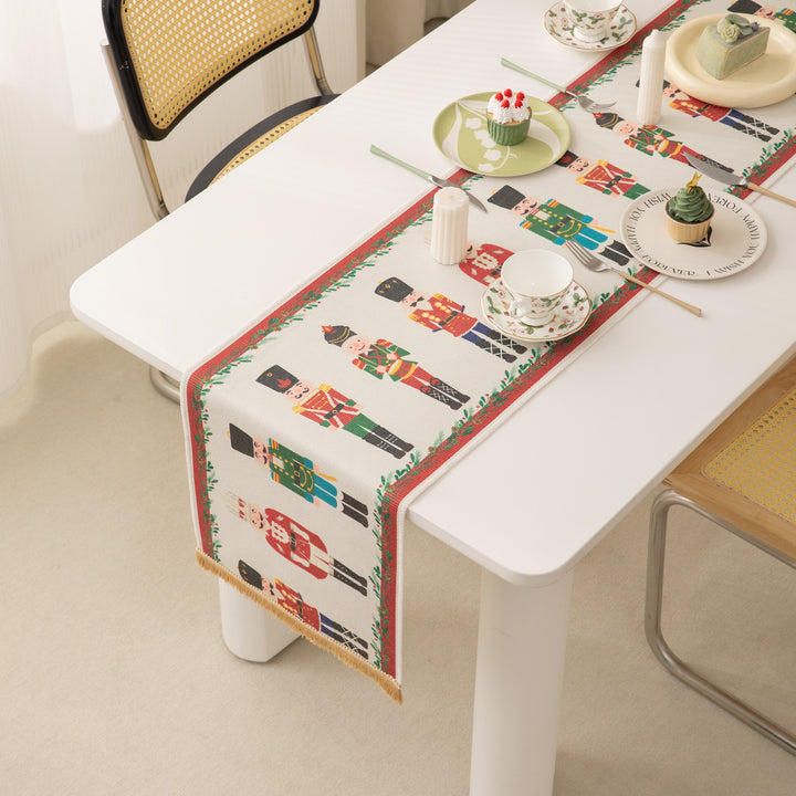 Festive woven table runner with nutcracker motif and golden fringes