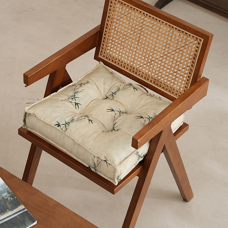 Padded square seat cushion with tufted stitching and fine bamboo print