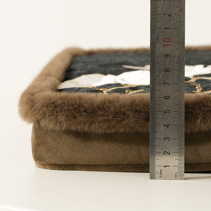 Padded seat cushion with velvet cover, floral embroidery and faux fur trim