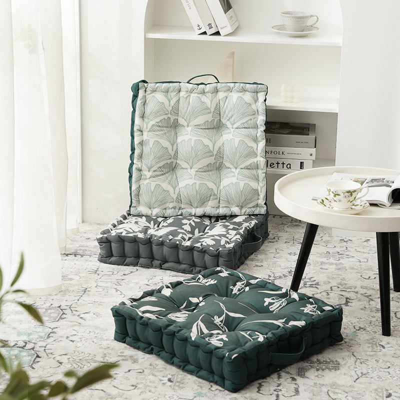 Padded chair cushion with carrying handle and decorative stitching
