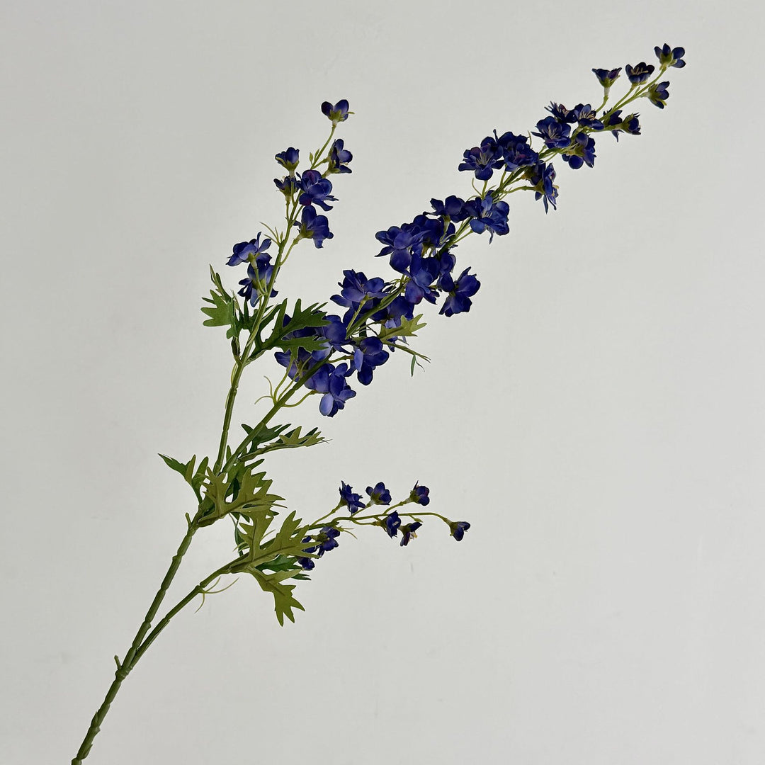 Artificial flower branch with intricately detailed red flowers