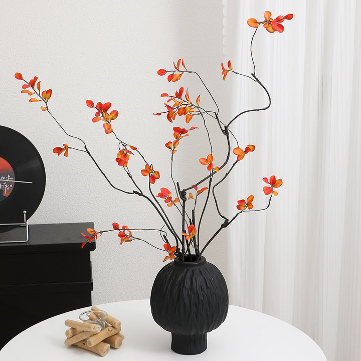 Artificial flower branch with vibrant orange flowers