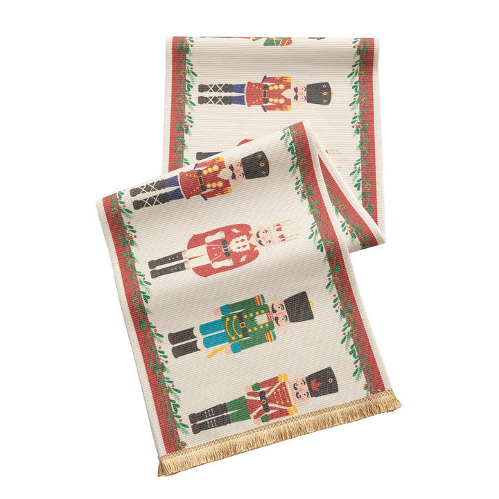 Festive woven table runner with nutcracker motif and golden fringes