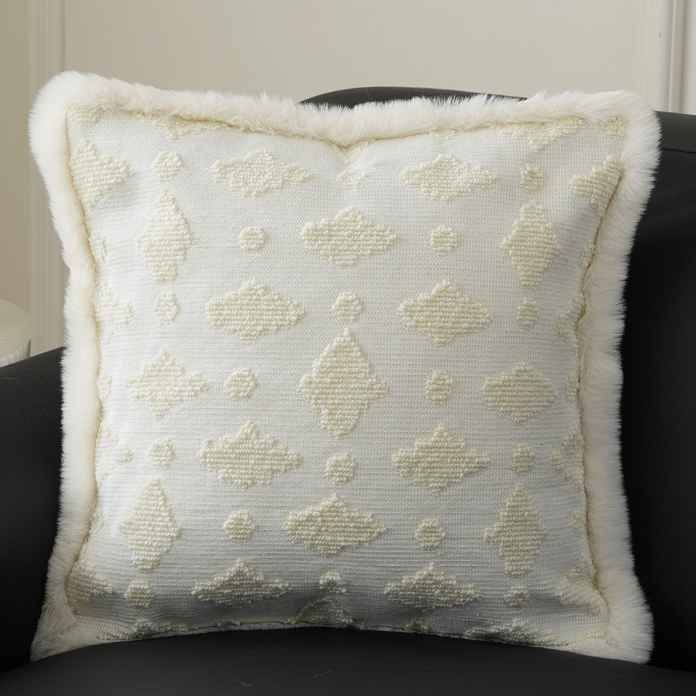 Square decorative pillow with embossed circular relief and soft faux fur edging