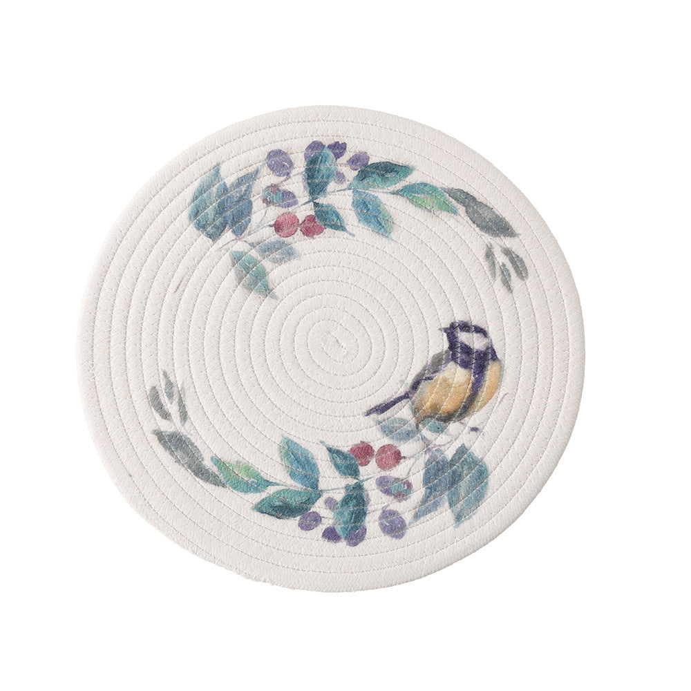 Round placemat made of woven cotton with a cute rhinoceros illustration and floral wreath