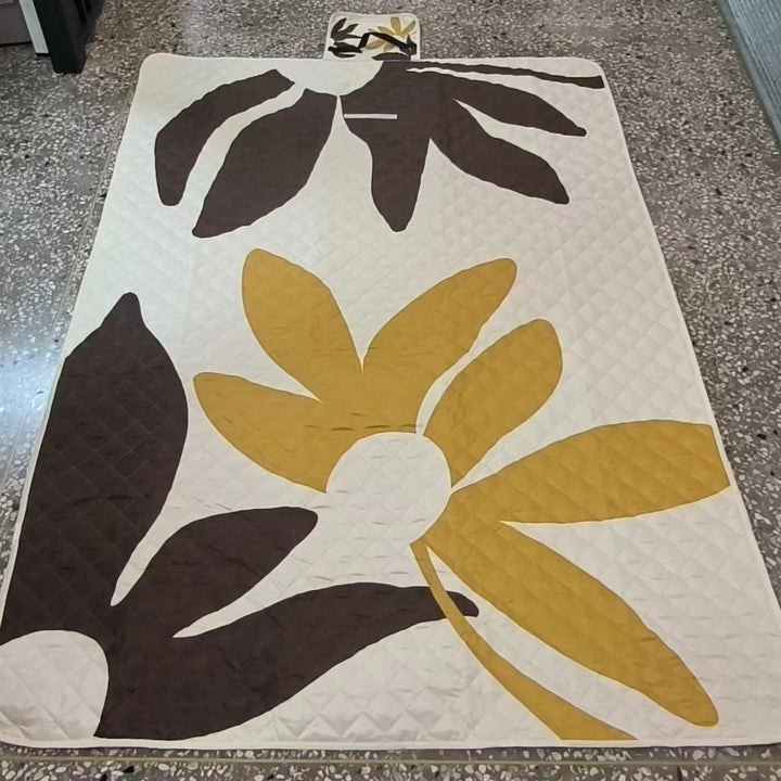 Quilted bedspread with large floral appliqué and diamond quilted relief