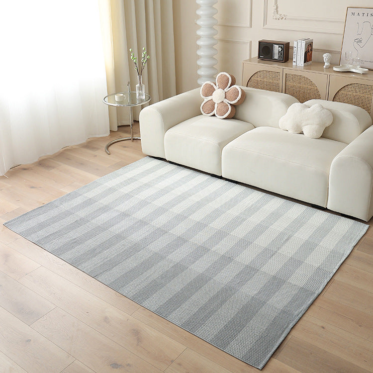 Woven living area rug with large check pattern and flat cotton texture