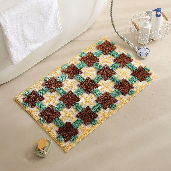 Hand-tufted bathroom bath mat with non-slip backing and textured square relief