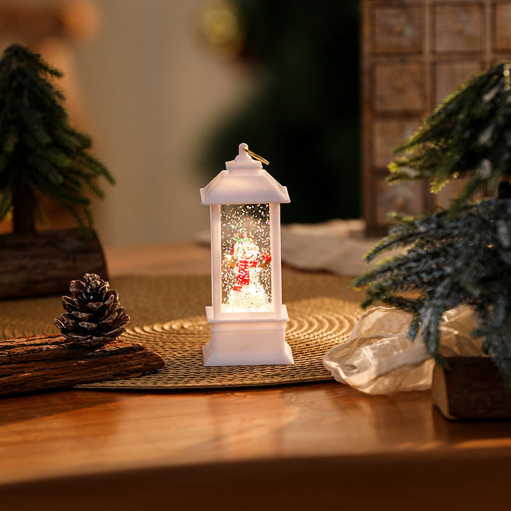 Illuminated Christmas lantern with glittering snowman scene