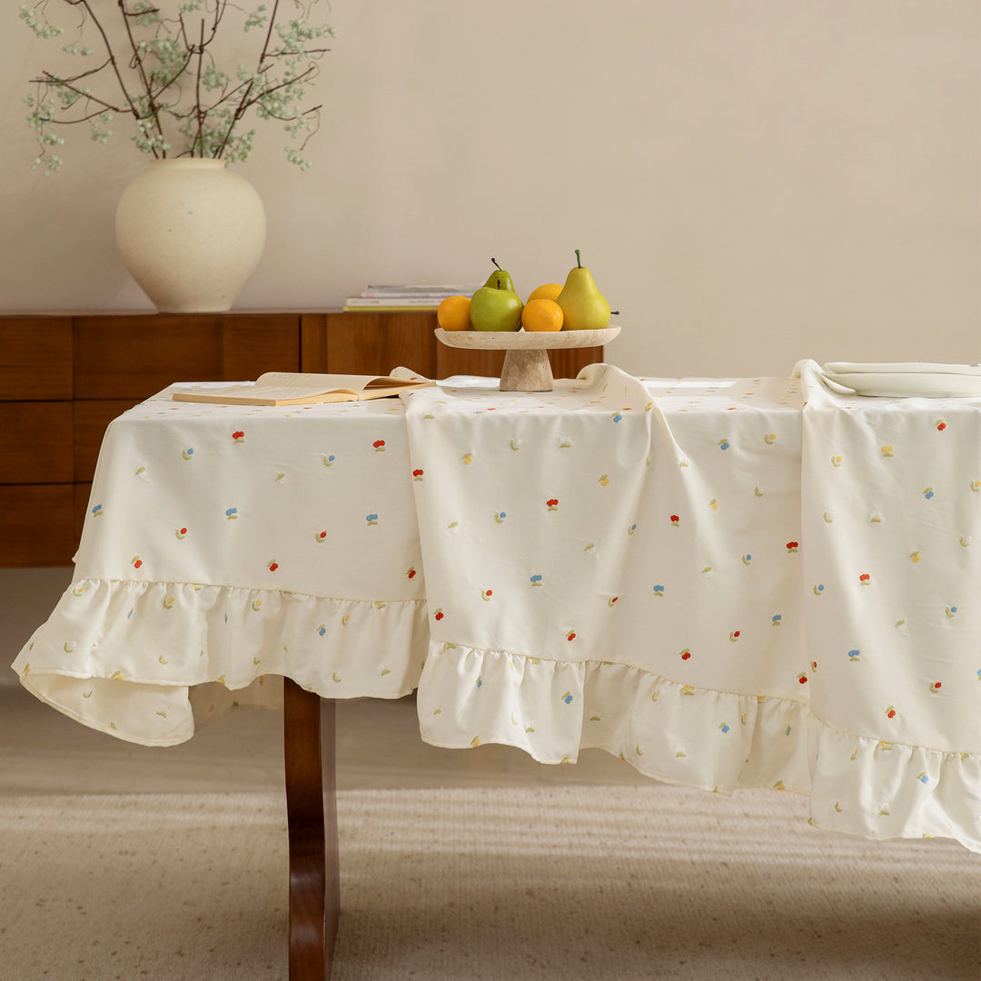 Embroidered tablecloth with ruffle and delicate floral relief
