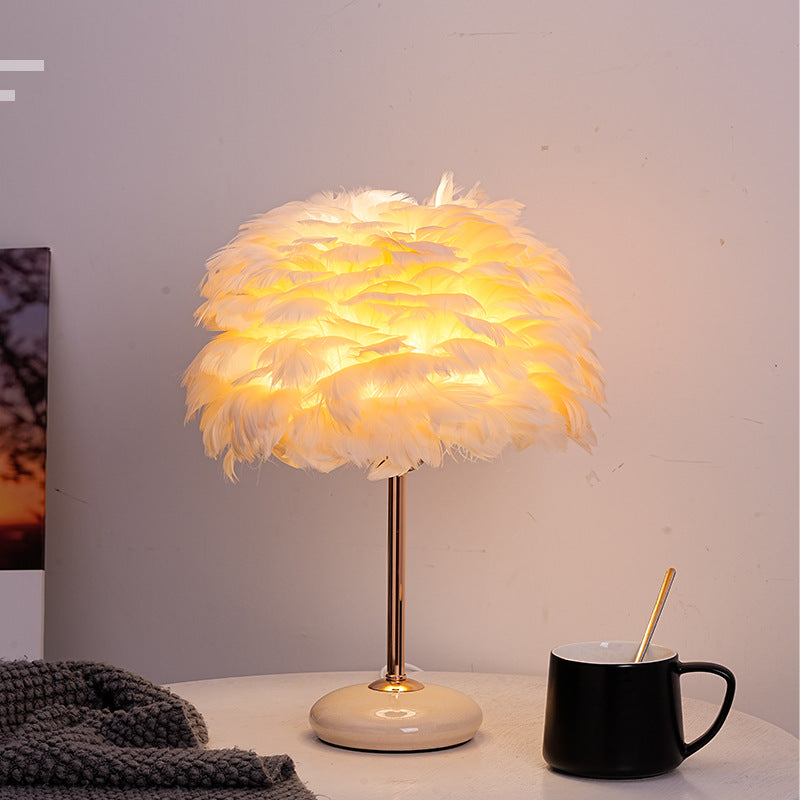 Feather shade table lamp with ceramic base and polished metal rod
