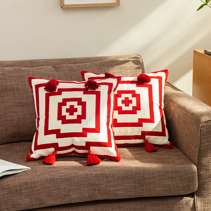 Square cushion cover in graphic geometric relief with decorative tassels