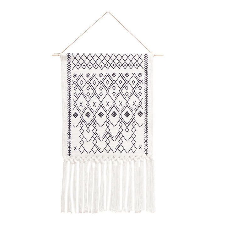 Woven Boho wall tapestry in Ethno design with long fringes and wood stick