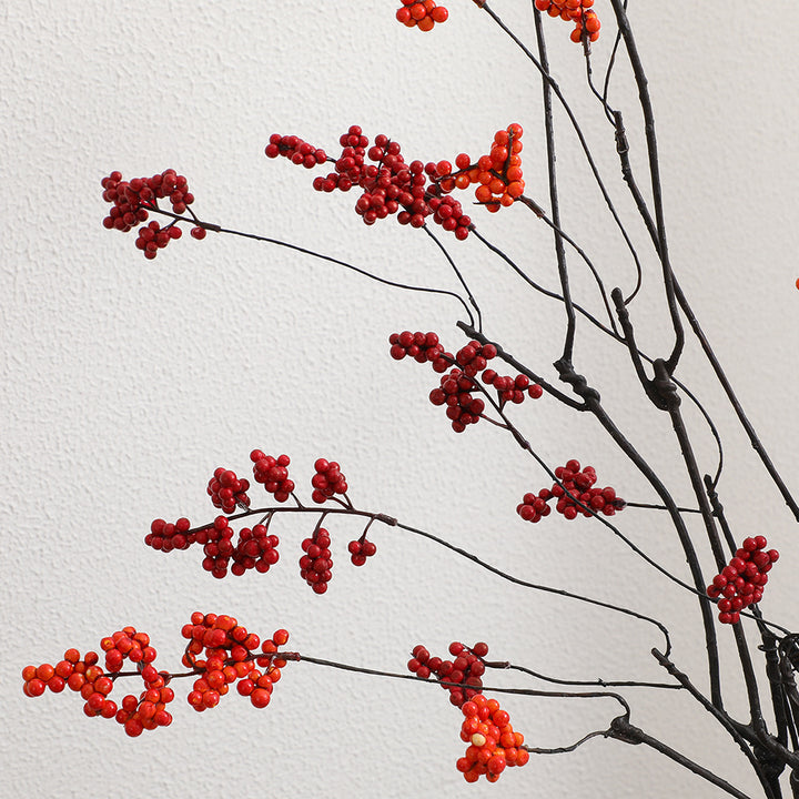 Decorative artificial flower branch with glowing red berries