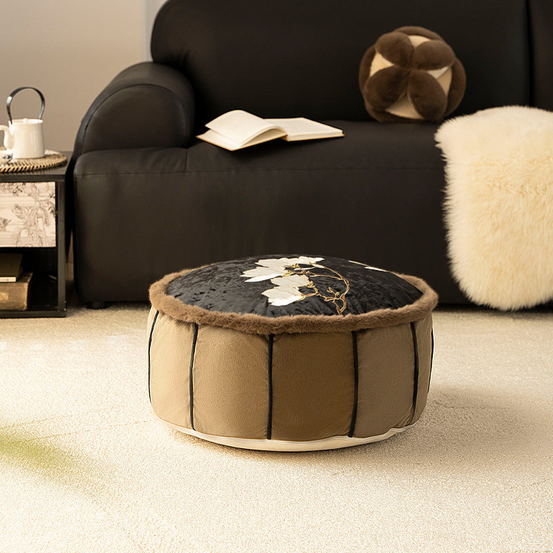 Round upholstered velvet floor cushion pouf with faux fur trim and handle