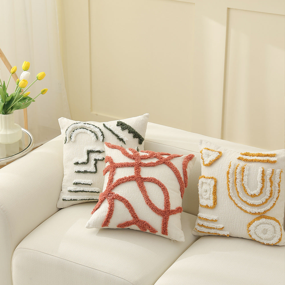 Geometric tufted sofa cushion with textured loop appliqué and removable cover