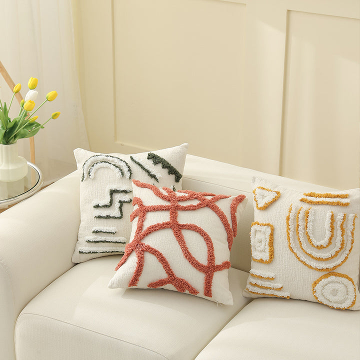 Geometric tufted sofa cushion with textured loop appliqué and removable cover